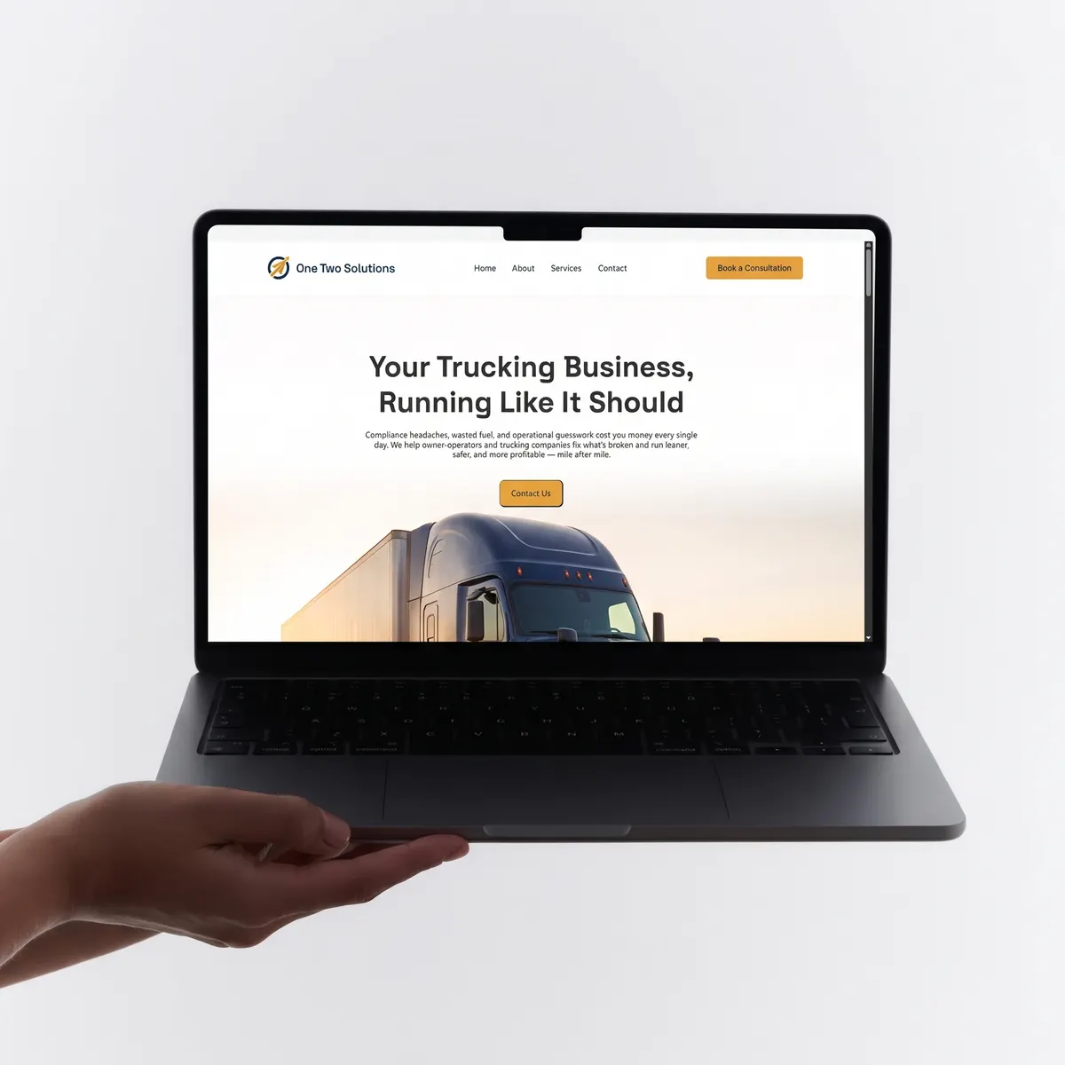 One Two Solutions website shown on a laptop